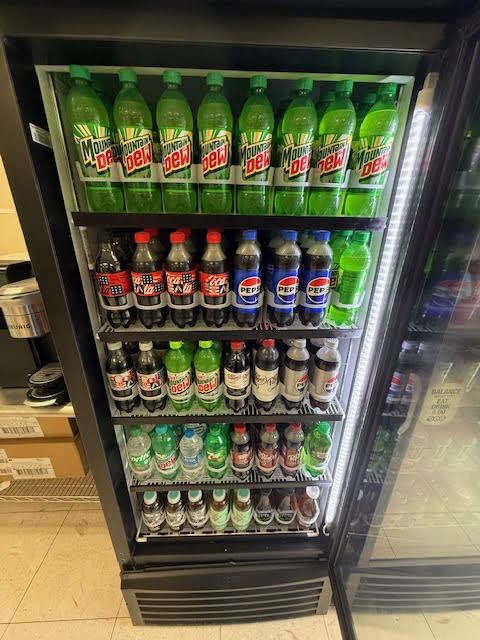 Cooler stocked with Mountain Dew, Pepsi, and other soda