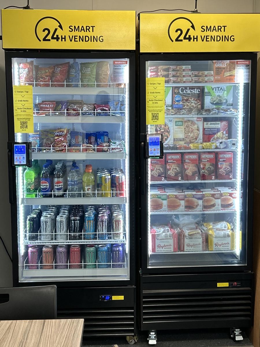 Two BMV smart vending coolers stocked with snacks, frozen meals, and drinks